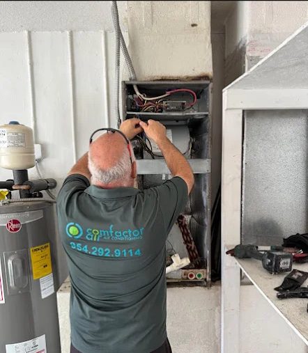 Comfactor Air technician servicing an indoor air handler