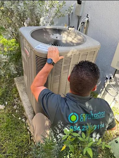 Comfactor Air technician working on an outdoor condenser unit